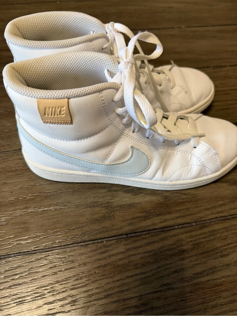 Nike White High-Top Sneakers with Light Blue Swoosh and Tan Heel Tab